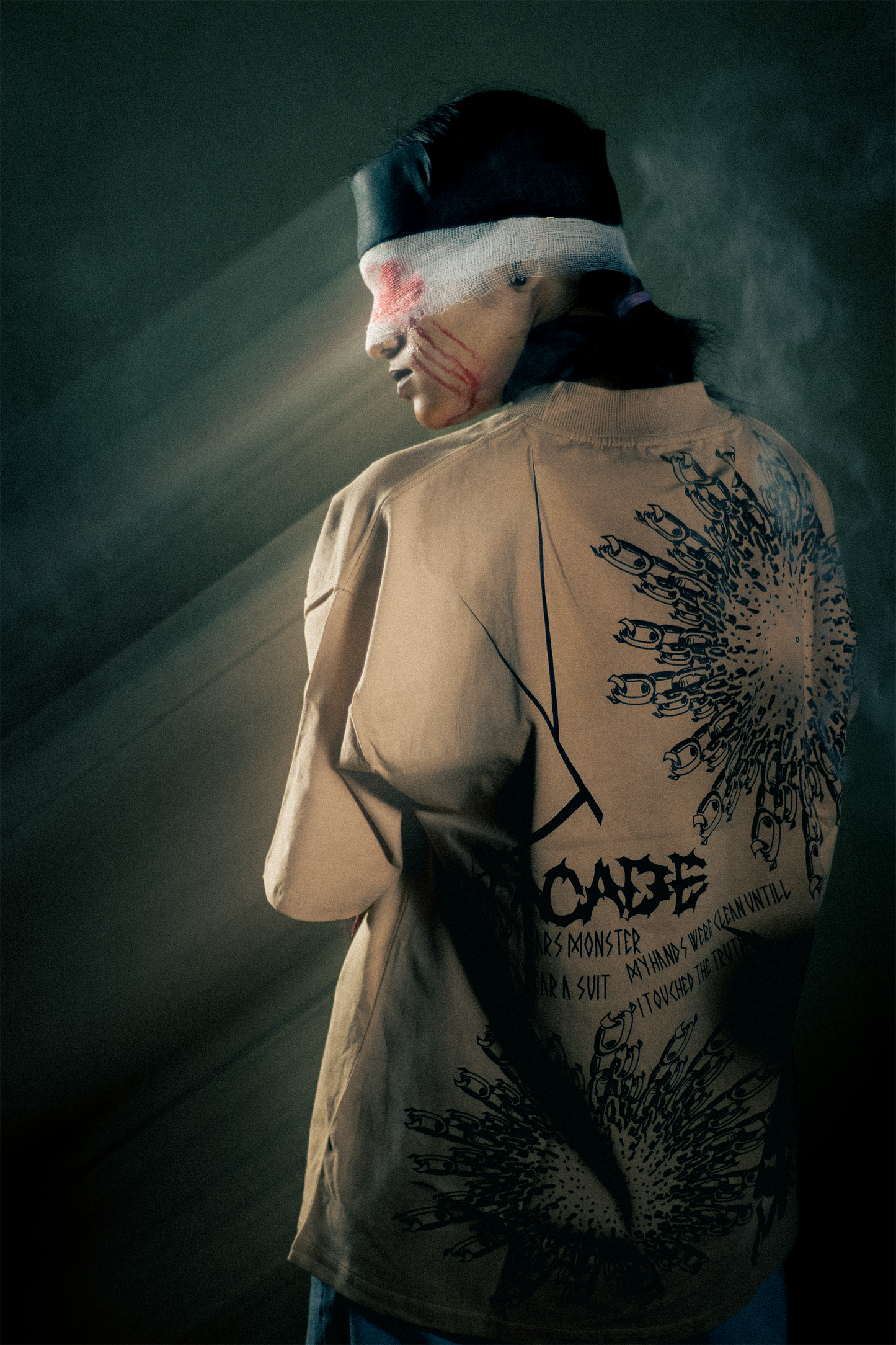 Model wearing oversized graphic t-shirt with dark abstract back design of facade premium streetwear India